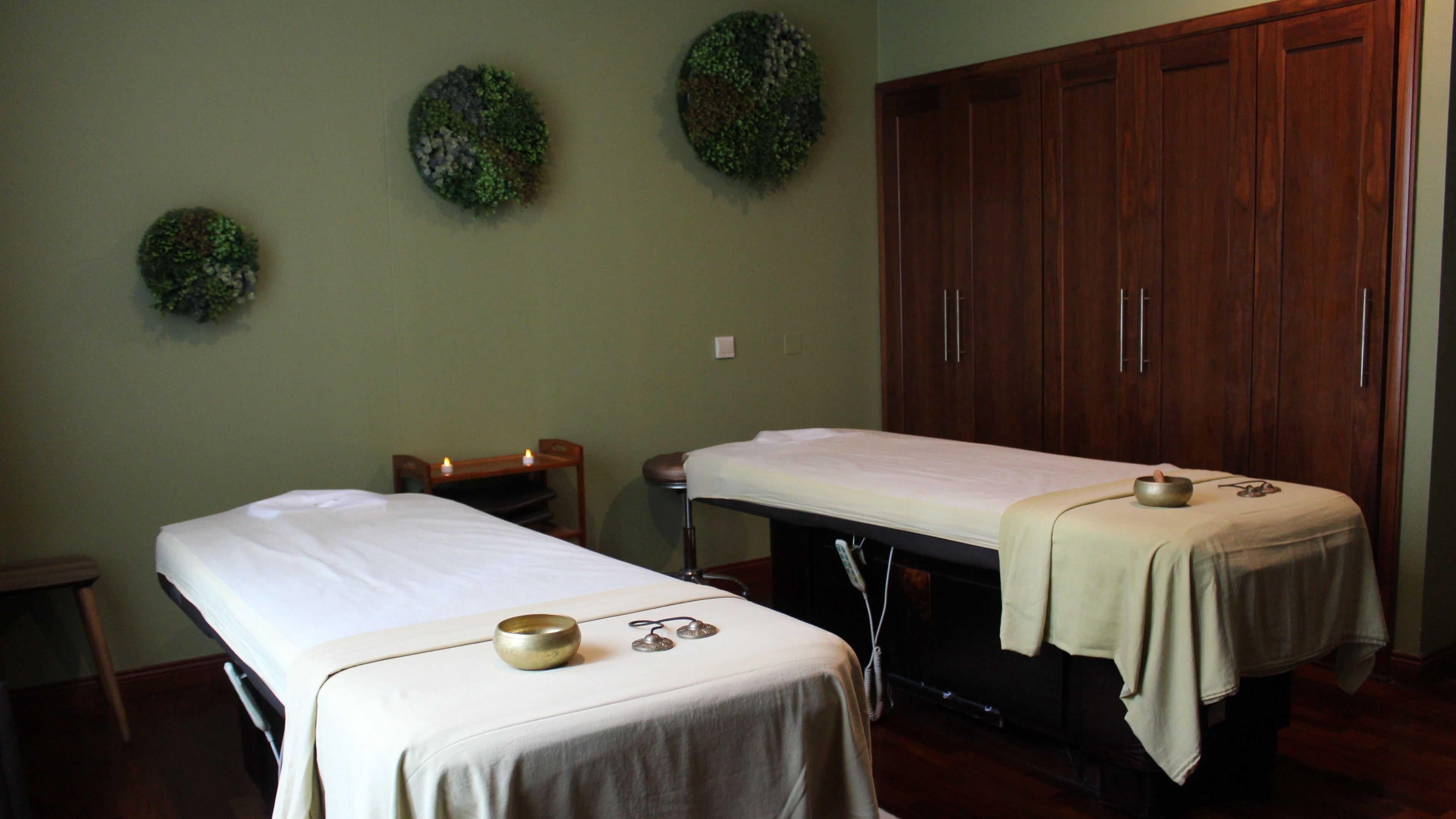 Relaxing treatment room at Rayya Wellness, Ramada Downtown in Dubai, Dubai, AE with massage tables.