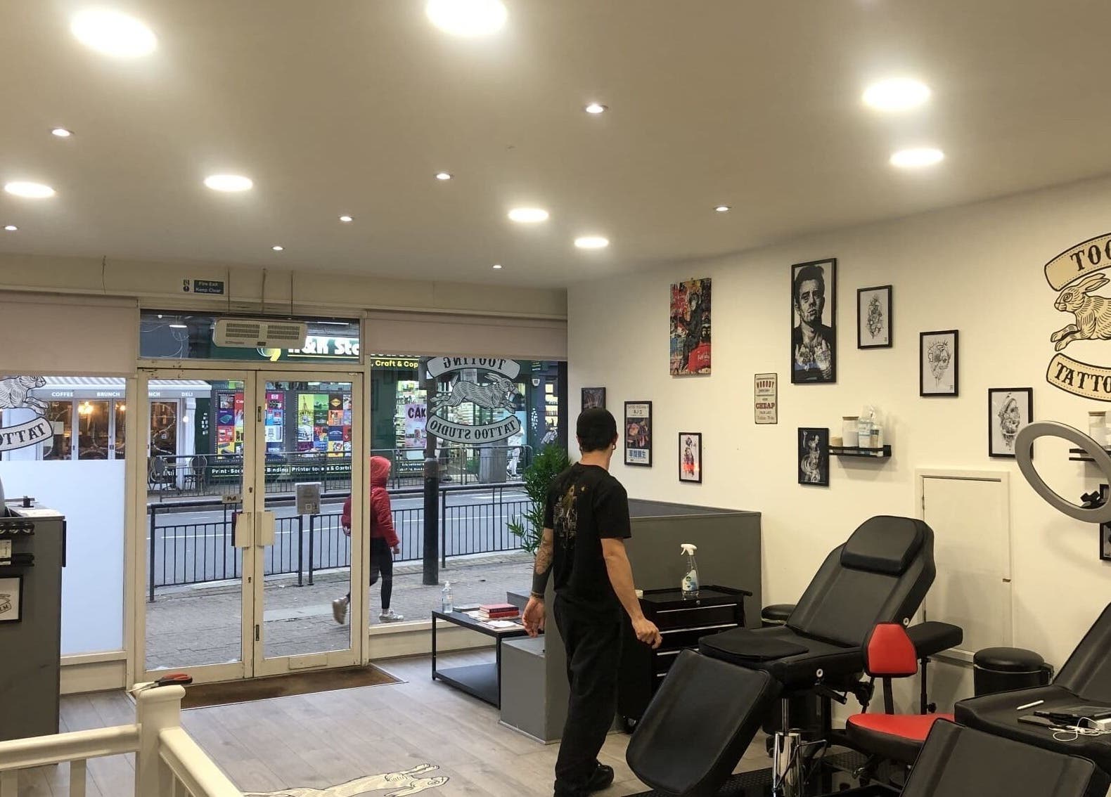 Interior view of Tooting Tattoo Studio in London, England, GB, showcasing its modern and artistic design.