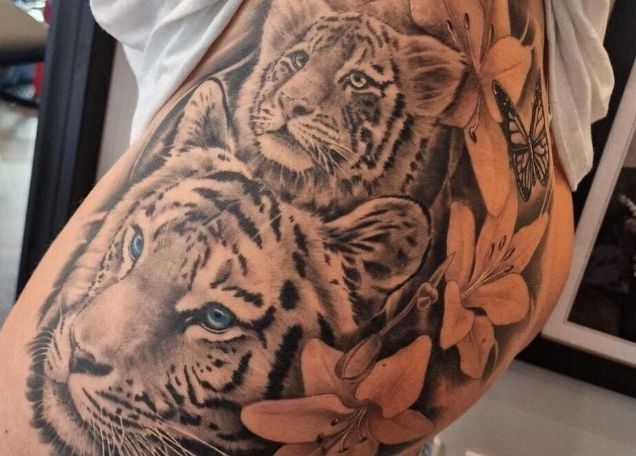 Detailed tiger and cub tattoo at Tooting Tattoo Studio, London, England, GB, showcasing exceptional artistry.