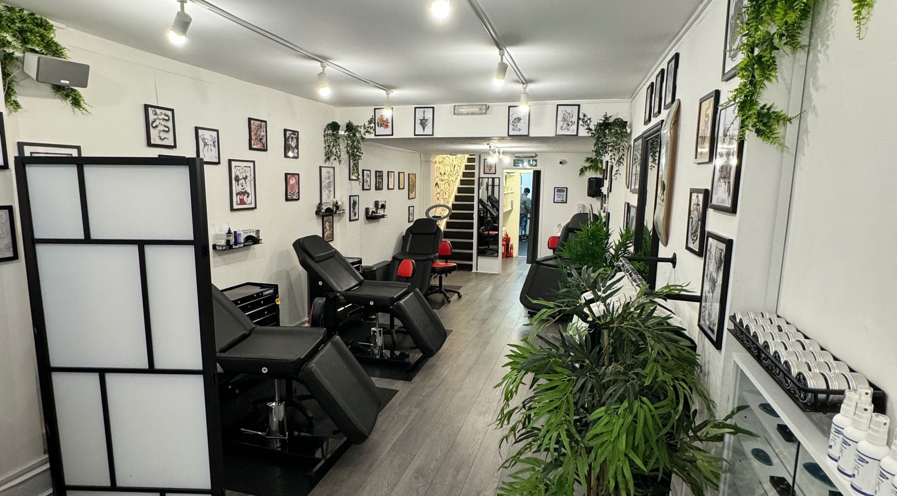 Interior of Worcester Park Tattoo, featuring modern decor and tattoo stations in Worcester Park, England, GB.