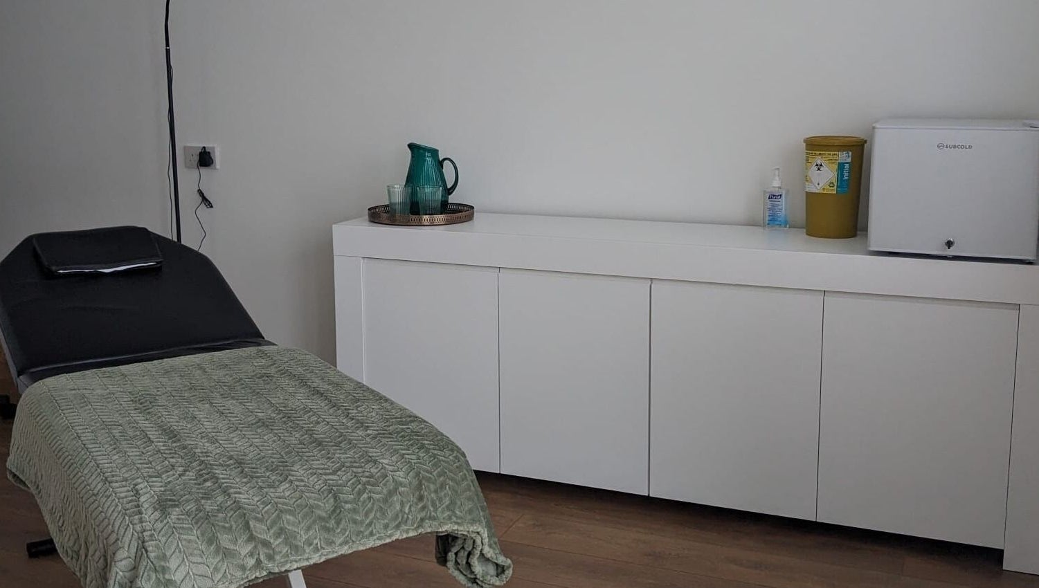 Relaxing treatment room at SALO Aesthetics, Plymouth, England, GB featuring a comfortable bed and clean decor.