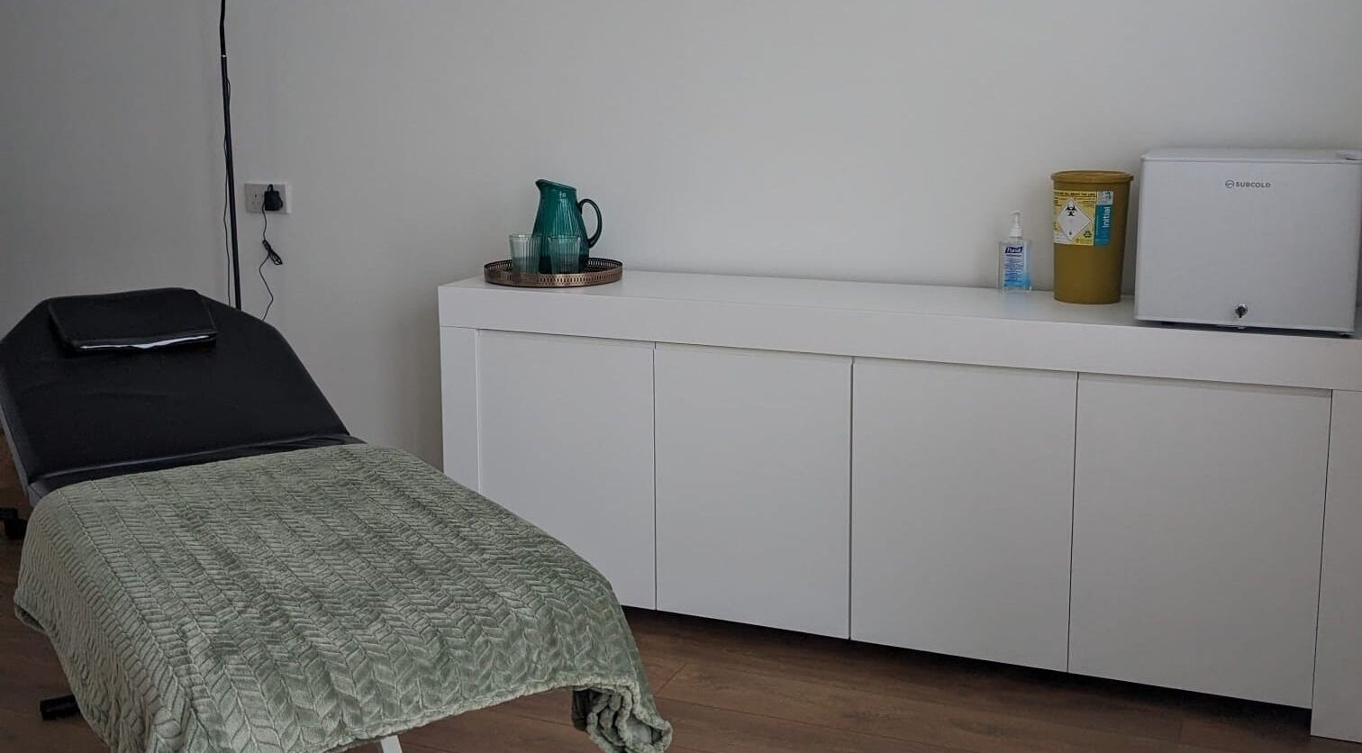 Relaxing treatment room at SALO Aesthetics, Plymouth, England, GB featuring a comfortable bed and clean decor.