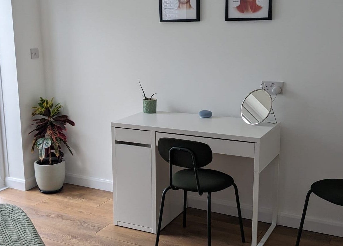 Cozy beauty station at SALO Aesthetics, Plymouth, England. White desk, mirror, plants enhance the space.