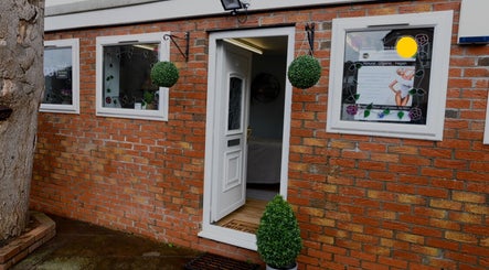 Warm entrance of Jel Beauty in Sully, Wales, GB, featuring decorative plants and welcoming decor.