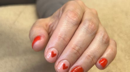 Red heart nail design at Bare Beauty, Strensall, England for chic and elegant look.