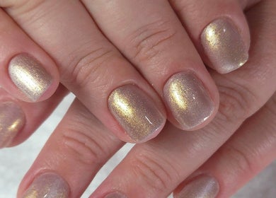 Glittering gold manicure at Shardilly Nails, Hebburn, England, GB showcasing elegant nail design.
