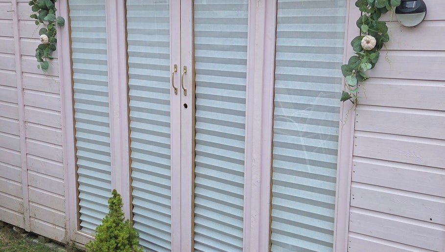 Elegant glass door at Shardilly Nails in Hebburn, England, GB, with decorative greenery.