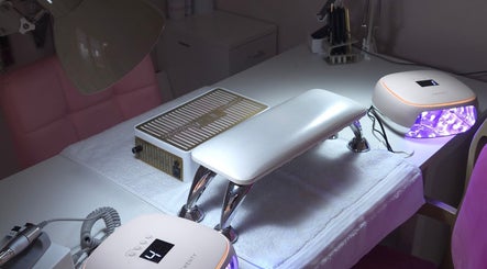 Modern nail station at Shardilly Nails in Hebburn, England, GB with vibrant LED tools and cushioned chairs.