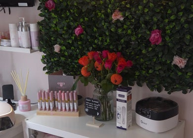 Elegant nail salon setup at Shardilly Nails in Hebburn, England featuring greenery and vibrant flowers.