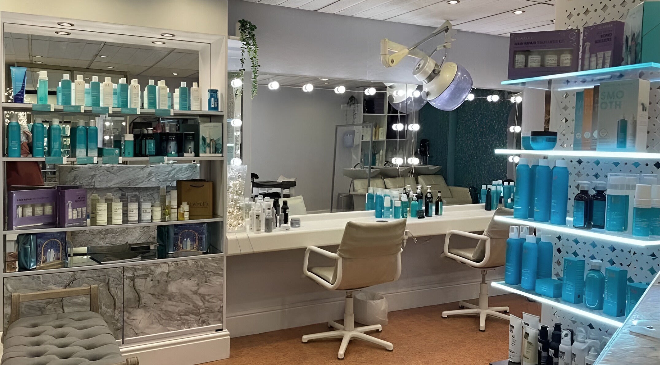 Luxury beauty salon interior at Through The Looking Glass, Yatton, England, GB showcasing elegant product displays.