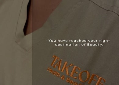 Close-up of Take Off Beauty Clinic uniform in Dubai, Dubai, AE with logo embroidery.
