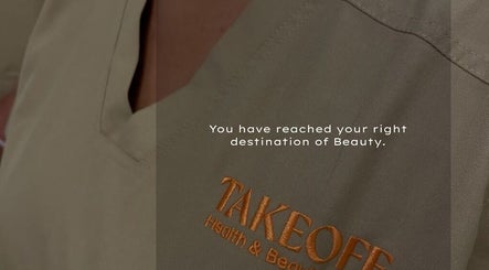 Close-up of Take Off Beauty Clinic uniform in Dubai, Dubai, AE with logo embroidery.