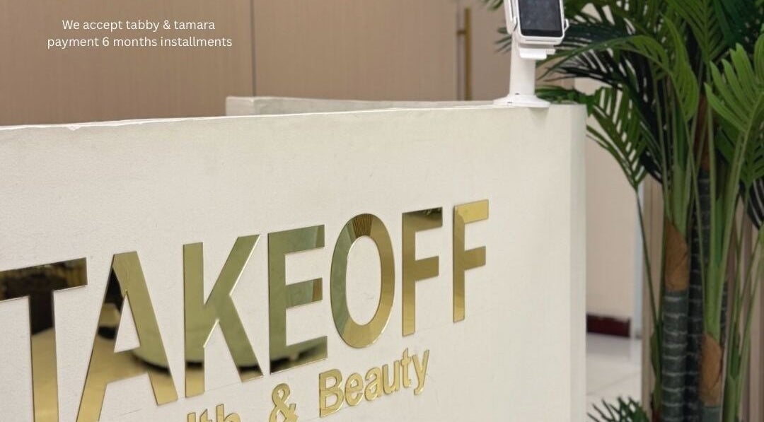 Reception area at Take Off Beauty Clinic, Dubai, Dubai, AE showcasing elegant design and lush greenery.