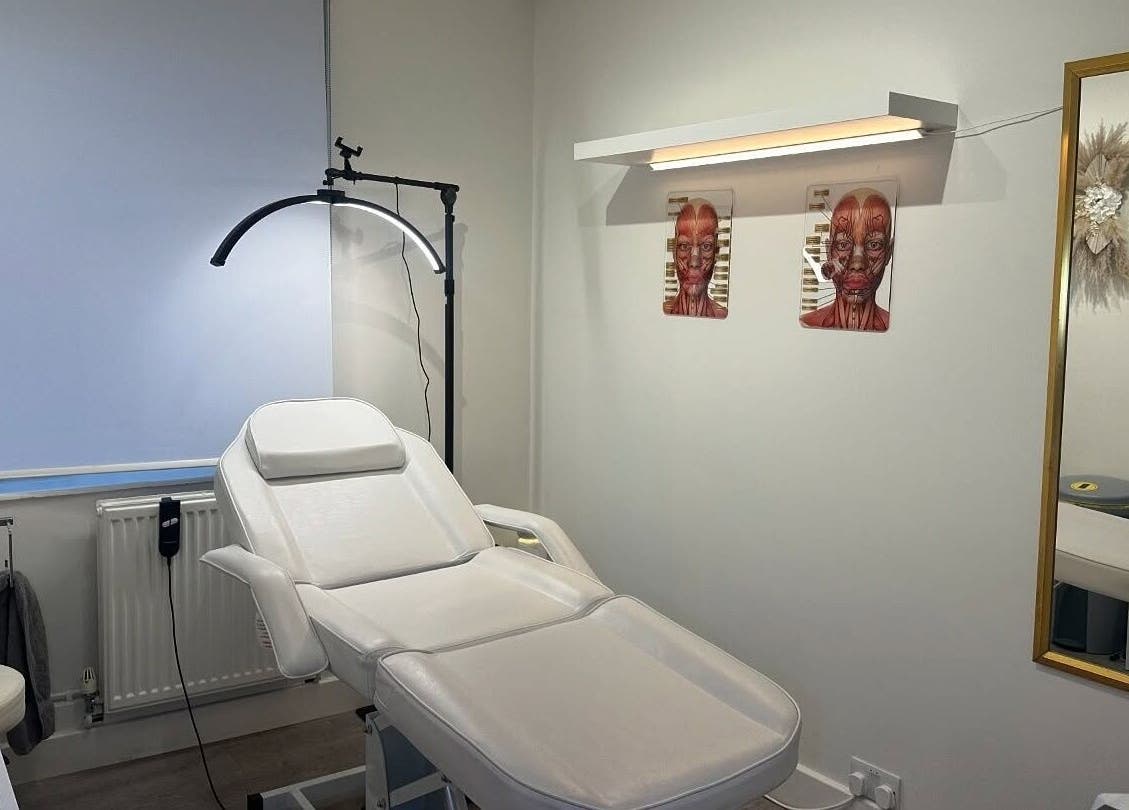 Modern treatment room at Facefull Aesthetics, London, England, GB featuring a comfortable white spa chair.