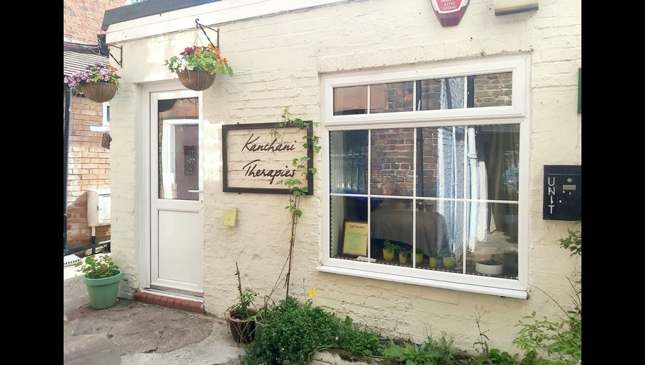 Front view of Kanchani Therapies in Leek, England with a welcoming entrance and vibrant hanging plants.