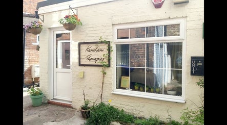 Front view of Kanchani Therapies in Leek, England with a welcoming entrance and vibrant hanging plants.