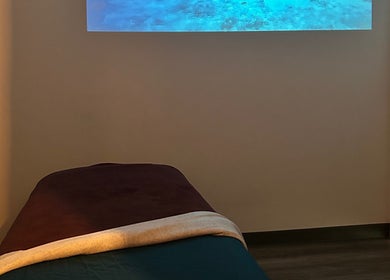 Relaxing massage room at BelaVita Wellness, Winter Garden, Florida, US with calming blue projections.