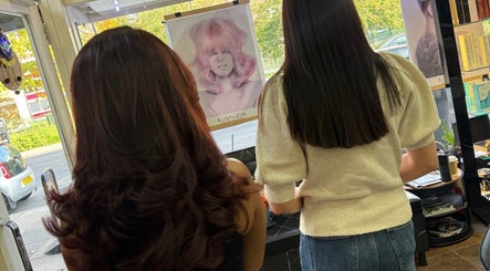 Clients at Bita Hair Studio in Southampton, England, GB gazing at hair trend posters.