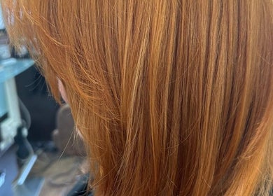 Vibrant ginger hair styled at Bita Hair Studio, Southampton, England, GB, showcasing expert coloring.