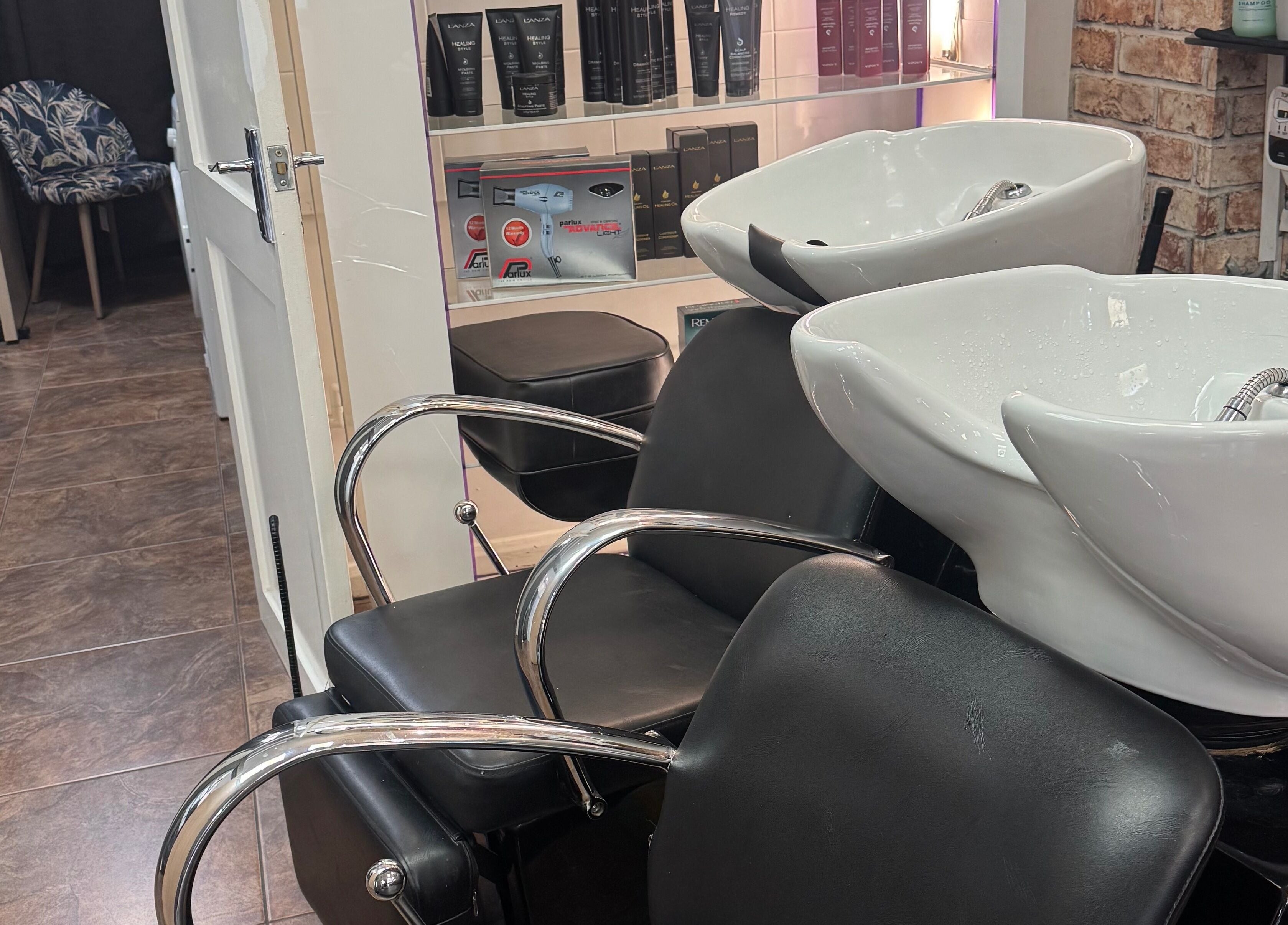 Modern wash station at Bita Hair Studio in Southampton, England, GB, featuring sleek chairs and shampoo bowls.