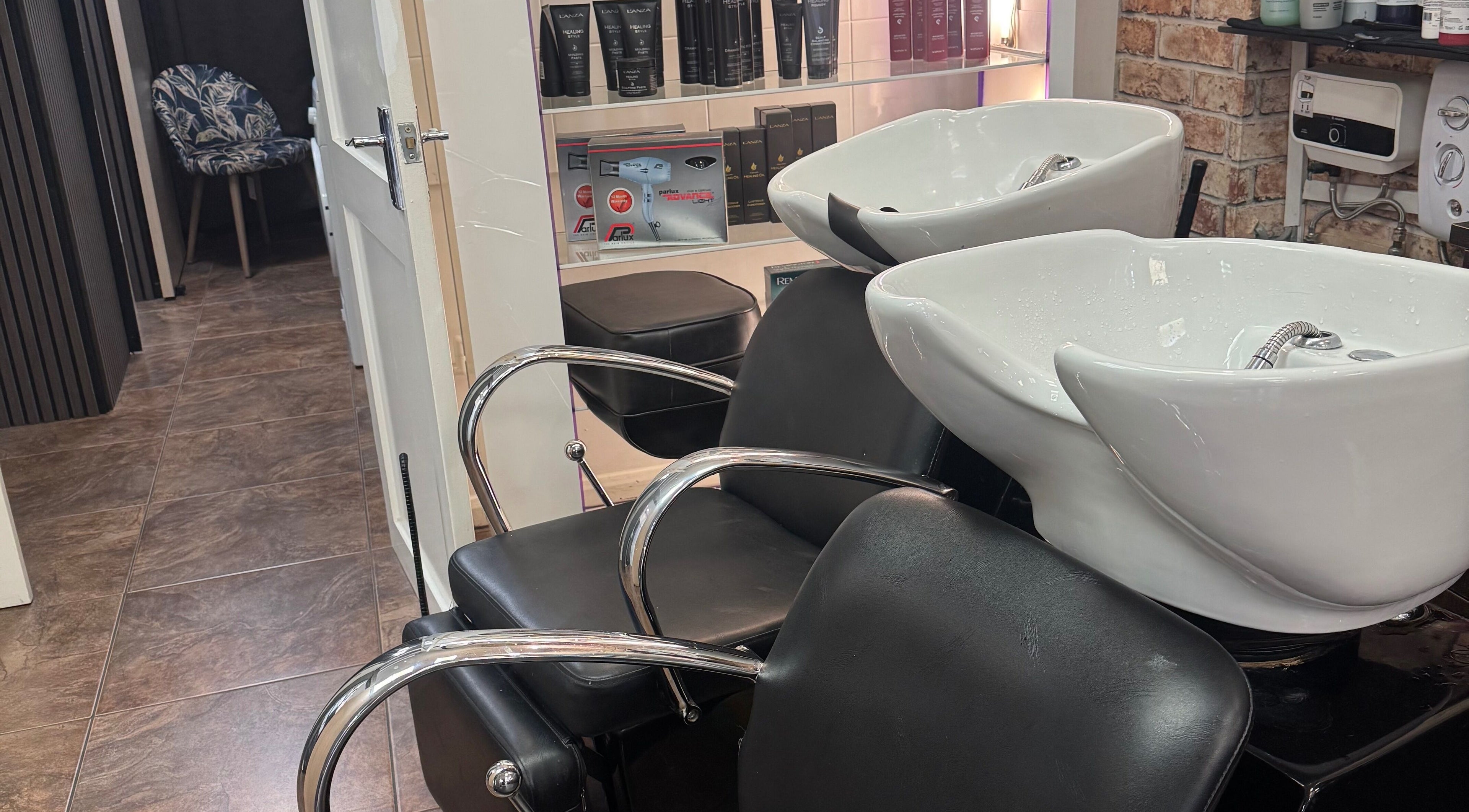 Modern wash station at Bita Hair Studio in Southampton, England, GB, featuring sleek chairs and shampoo bowls.