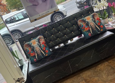 Cozy seating at Bita Hair Studio, Southampton, England, GB with vibrant elephant pillows.
