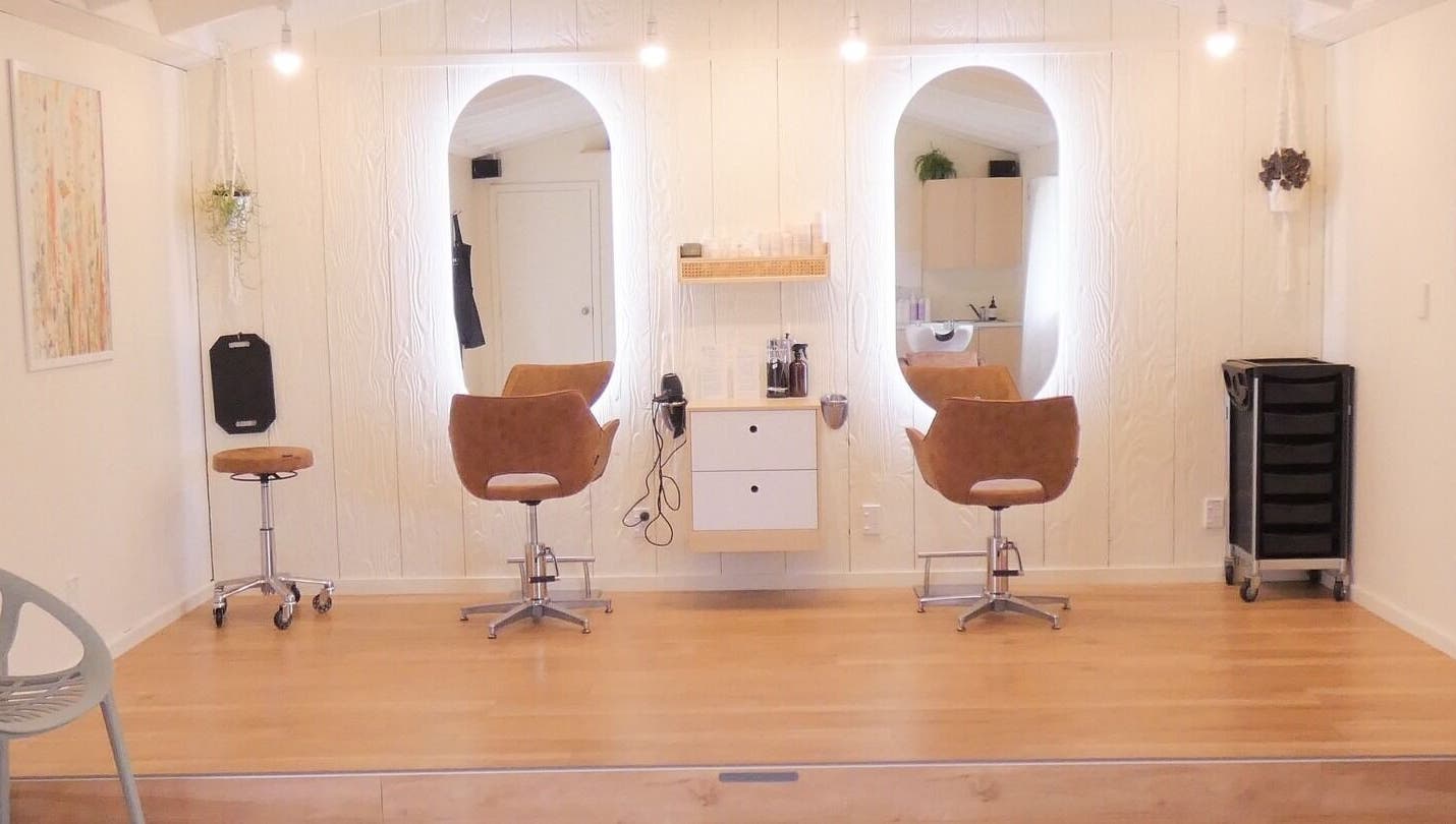 Chic and cozy interior of Gwen the Salon in Ohoka, Canterbury, NZ featuring stylish salon chairs and mirrors.
