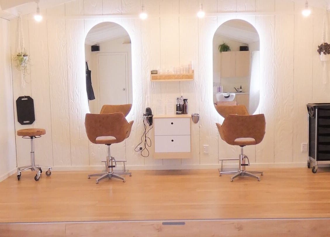 Chic and cozy interior of Gwen the Salon in Ohoka, Canterbury, NZ featuring stylish salon chairs and mirrors.