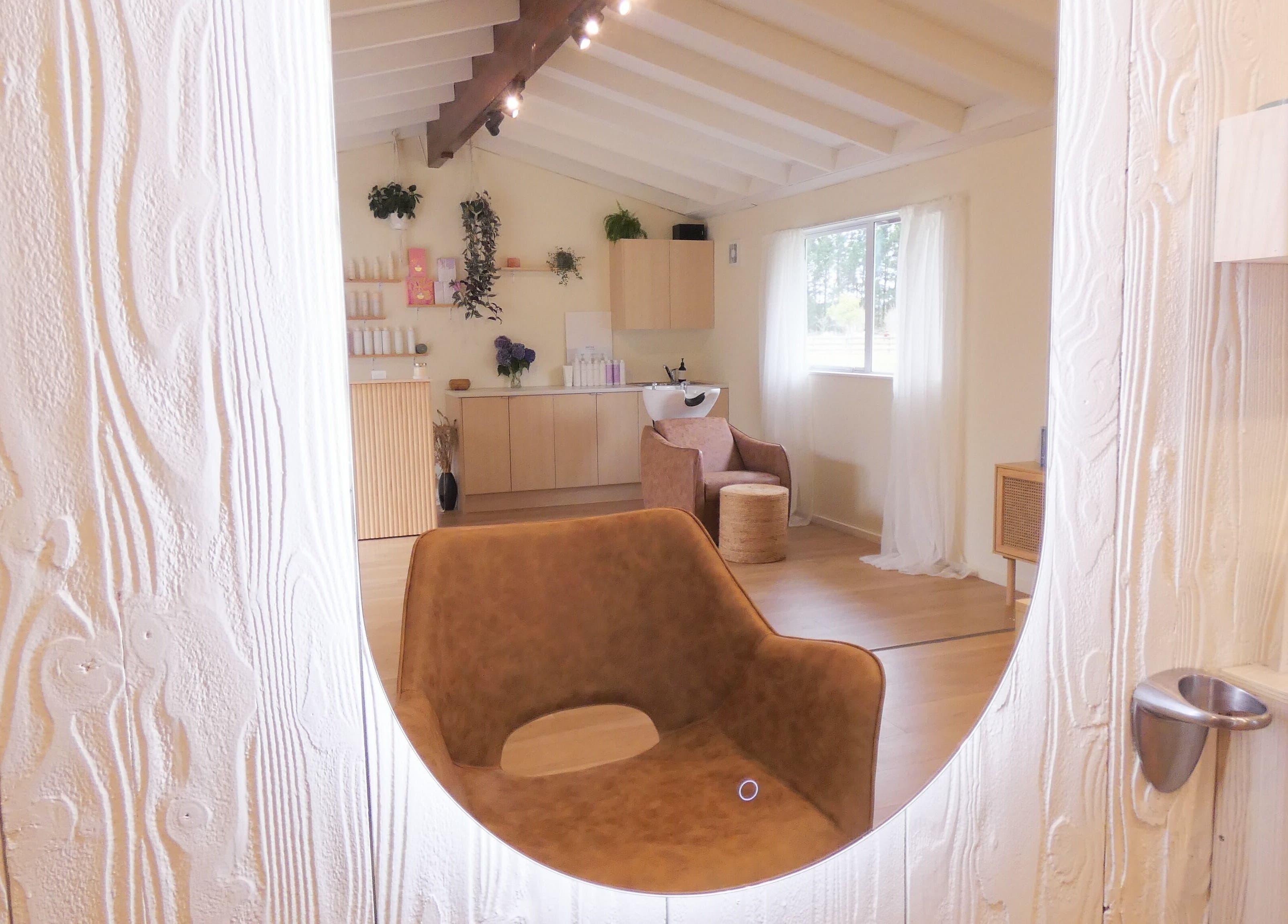 Relaxing and stylish interior of Gwen the Salon in Ohoka, Canterbury, NZ featuring modern decor and seating.