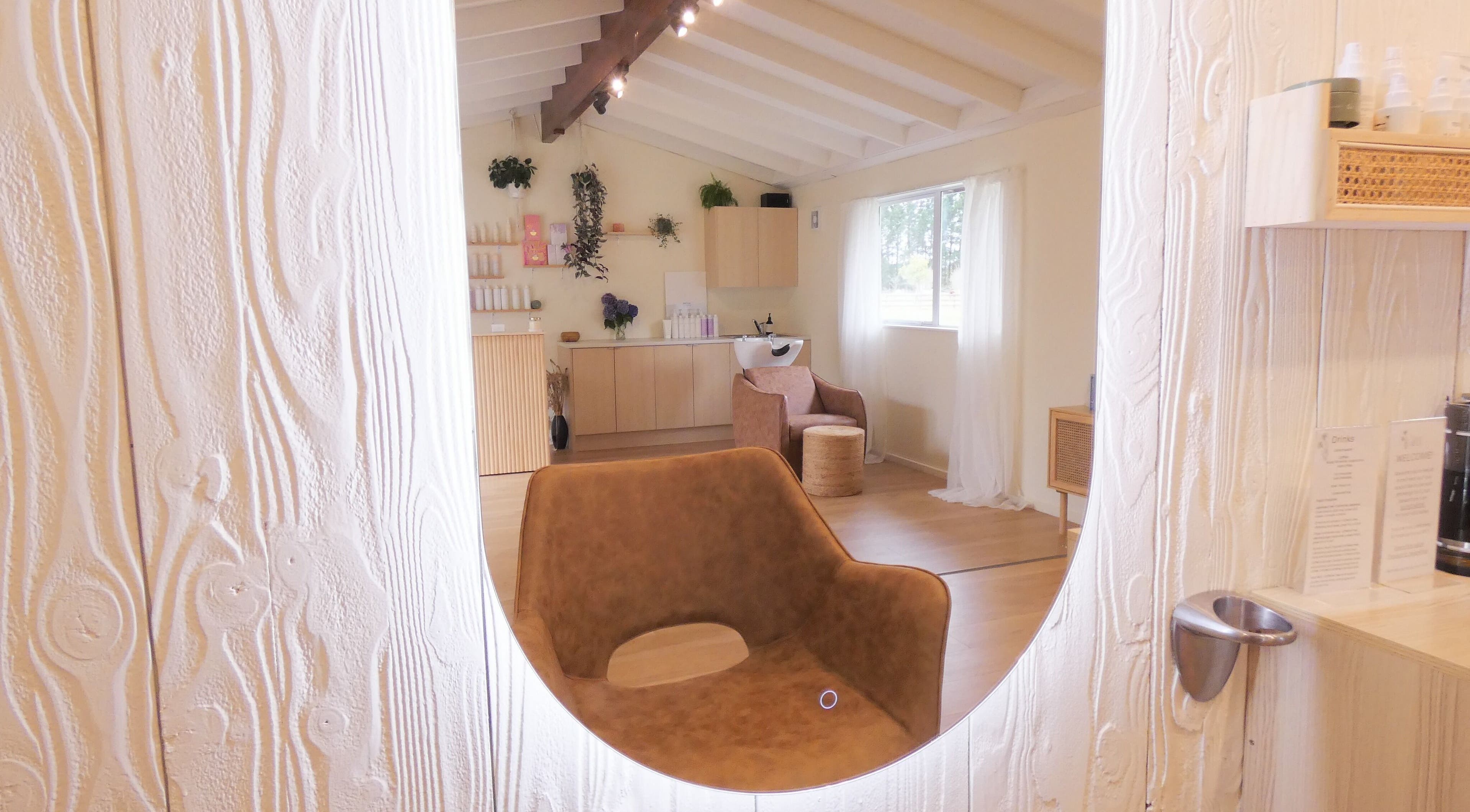 Relaxing and stylish interior of Gwen the Salon in Ohoka, Canterbury, NZ featuring modern decor and seating.