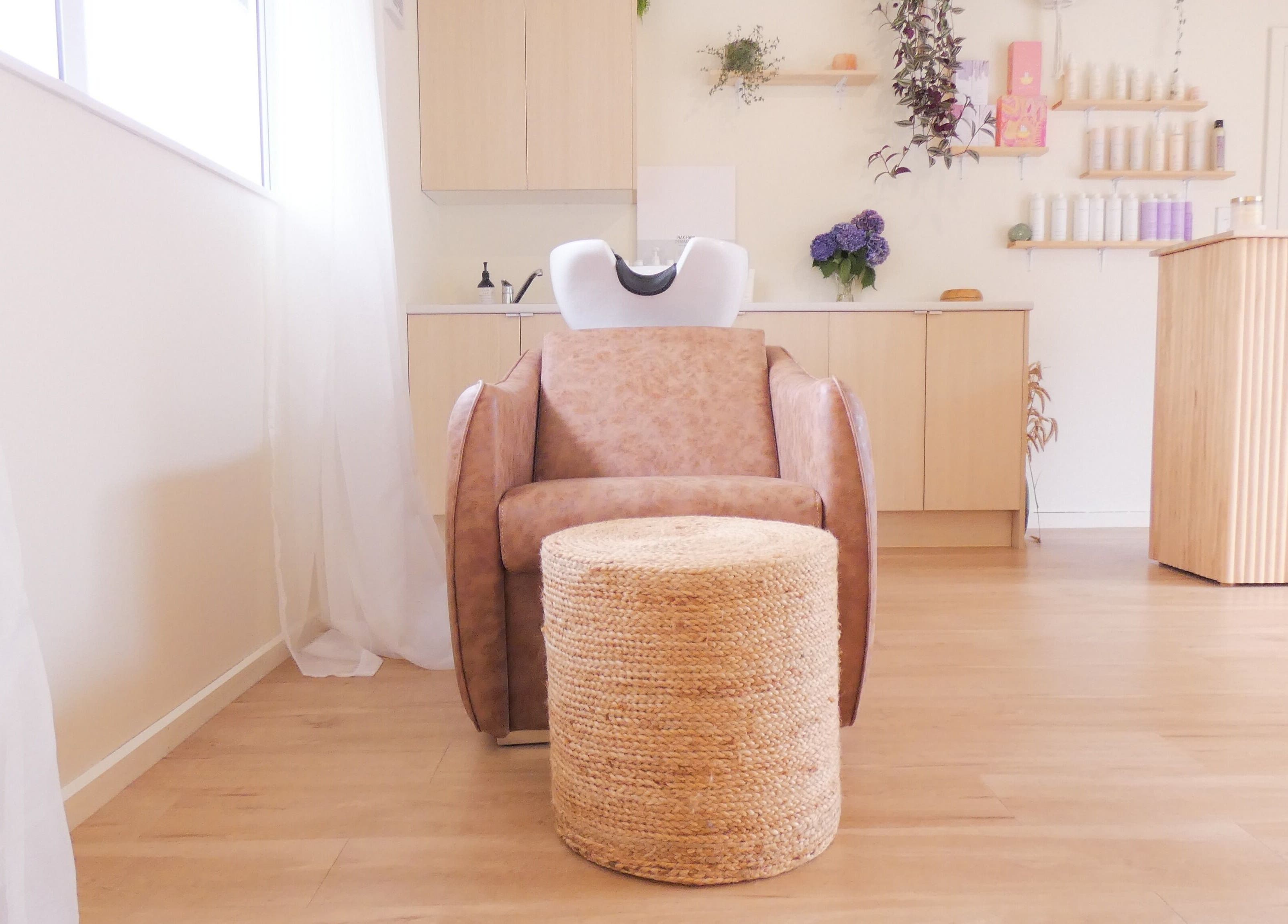 Relaxing washstation at Gwen the Salon in Ohoka, Canterbury, NZ, featuring cozy seating and stylish decor.