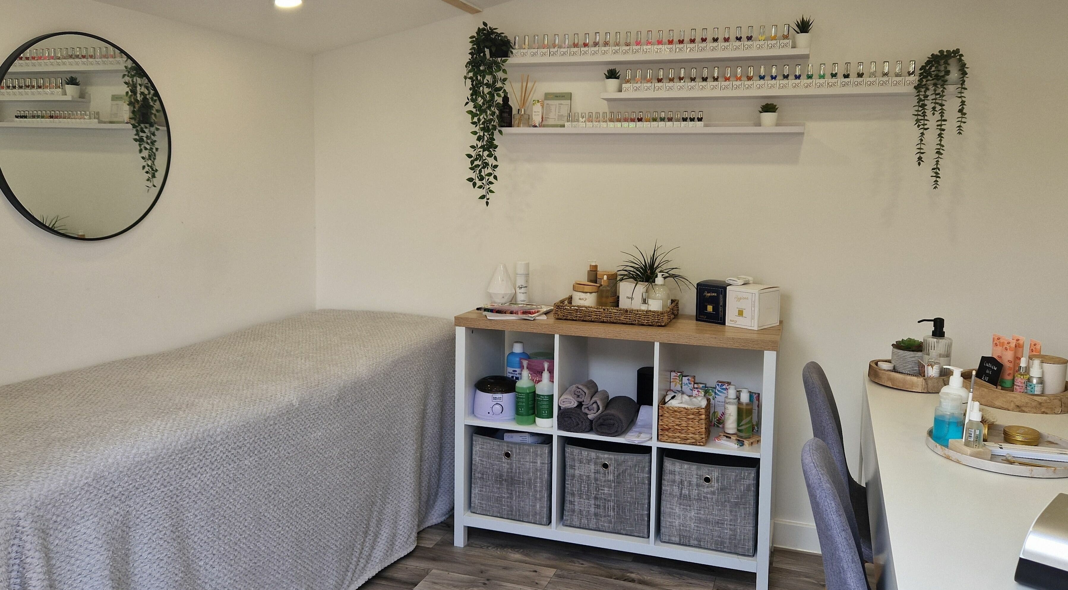 A serene treatment room at The Little Beauty Co, Lowestoft, England, GB, featuring a cozy bed and beauty products.