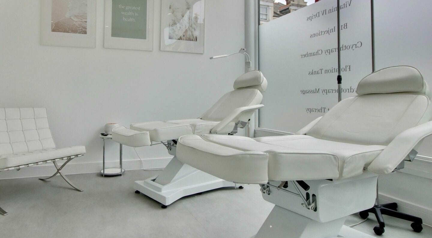 Relaxing white treatment room at Revive Southsea, Portsmouth, England, GB, offering premium wellness services.