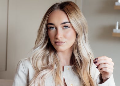 Woman with styled hair and glossy makeup at Nails By Lucy Walsh, Llansamlet, Wales, GB.
