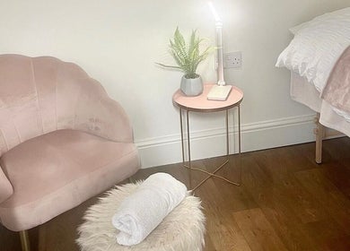 Relaxing corner at Sassy Beauty Collective Derby, featuring a plush chair and side table. Located in Derby, England, GB.