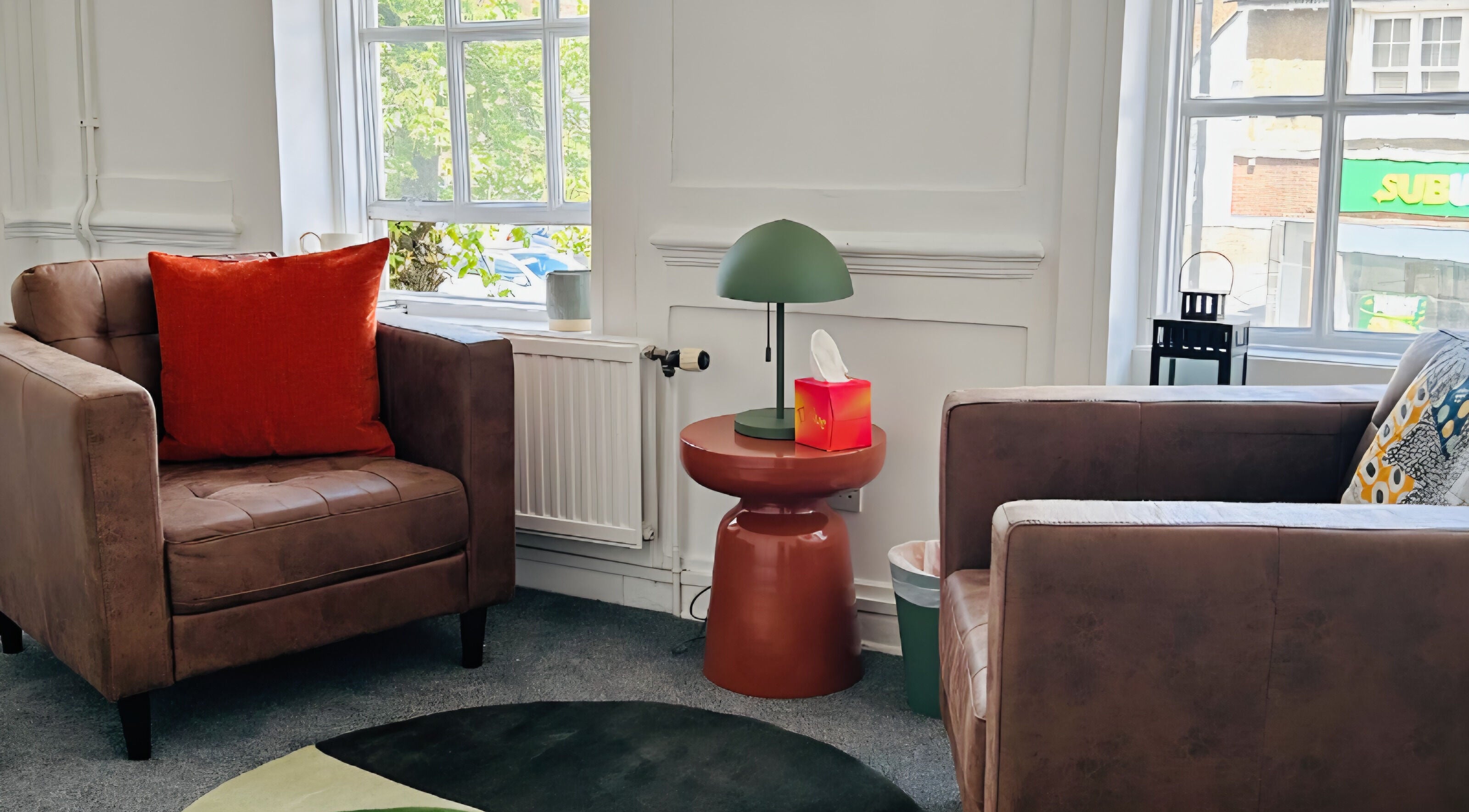 Inviting seating area at Royal Therapy Centre, Stevenage, England, GB with plush chairs and a stylish lamp.