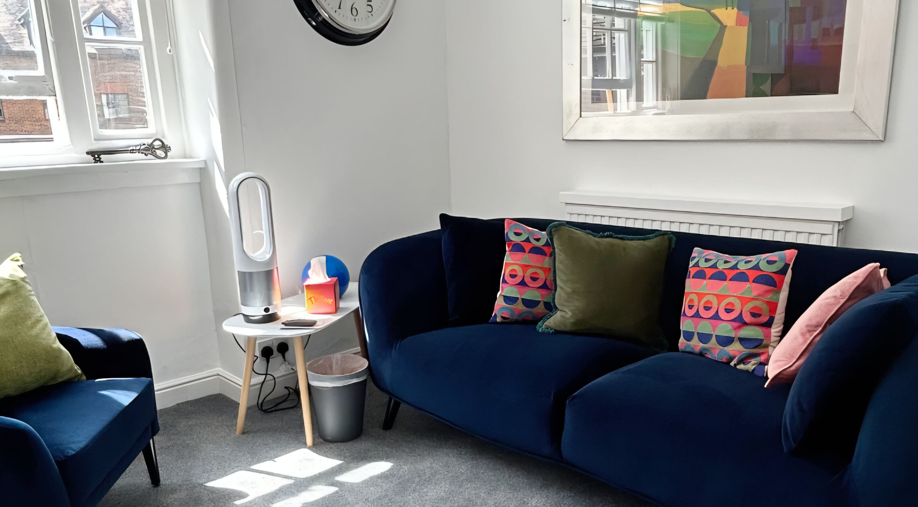 Elegant lounge at Royal Therapy Centre, Stevenage, England, GB with colorful cushions and modern decor.