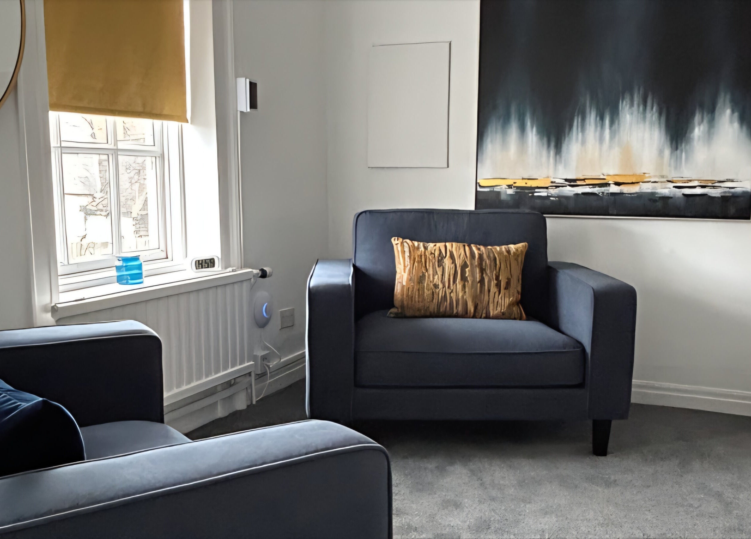 Relaxing lounge with blue armchairs at Royal Therapy Centre, Stevenage, England, GB; elegant decor enhances calm.