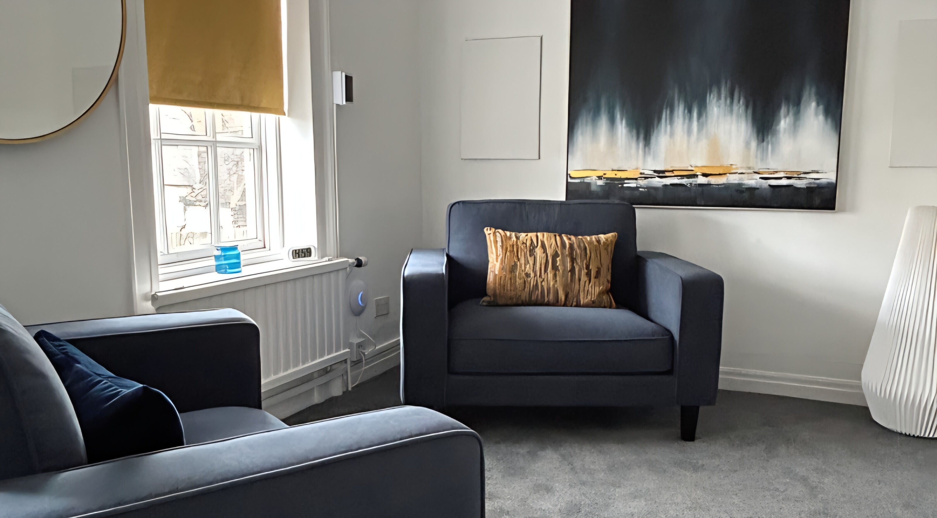 Relaxing lounge with blue armchairs at Royal Therapy Centre, Stevenage, England, GB; elegant decor enhances calm.