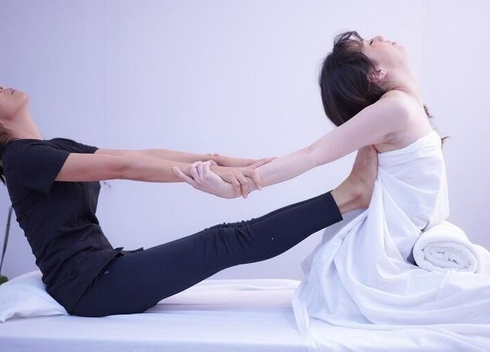 Therapist guiding a stretching session at Bua Thai Massage, Las Vegas, Nevada, US.