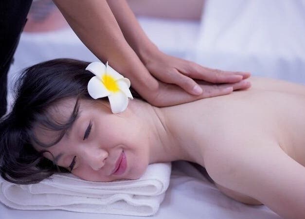 Relaxing massage at Bua Thai Massage, Las Vegas, Nevada, US with a flower-adorned client.
