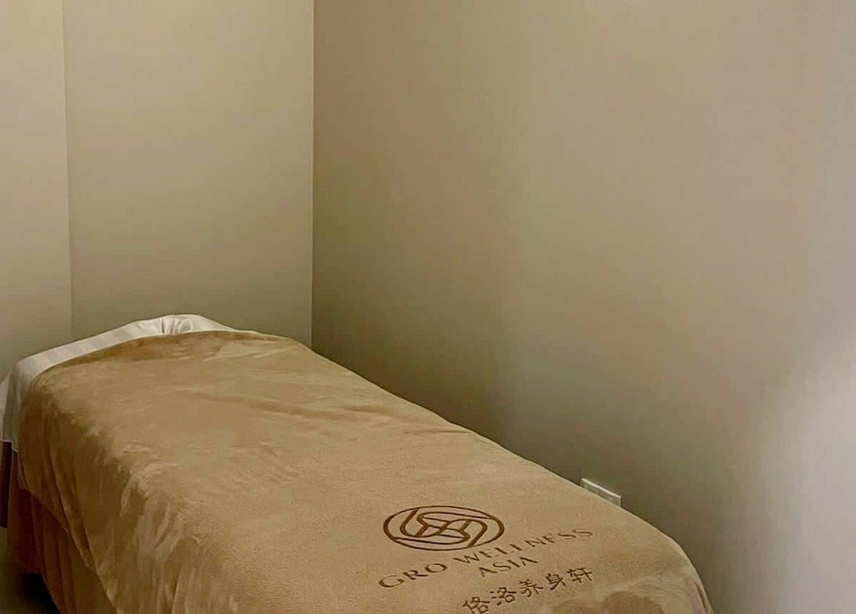 Tranquil massage room with a cozy bed at Gro Wellness Asia 佫洛养生轩 (Farrer Park), Singapore, Singapore, SG.