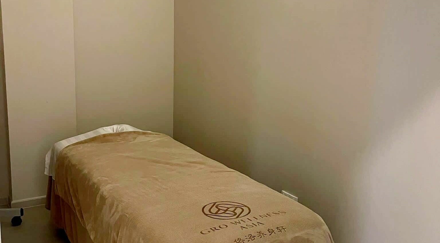 Tranquil massage room with a cozy bed at Gro Wellness Asia 佫洛养生轩 (Farrer Park), Singapore, Singapore, SG.