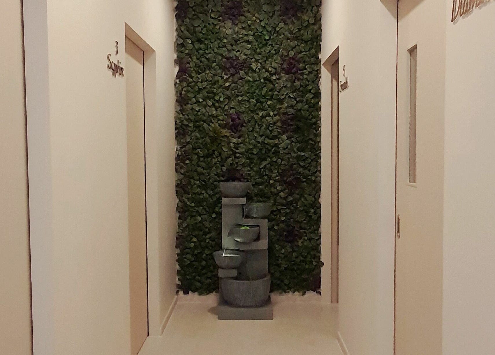 Tranquil hallway with green wall and water feature at Gro Wellness Asia 佫洛养生轩 (Farrer Park), Singapore, SG.