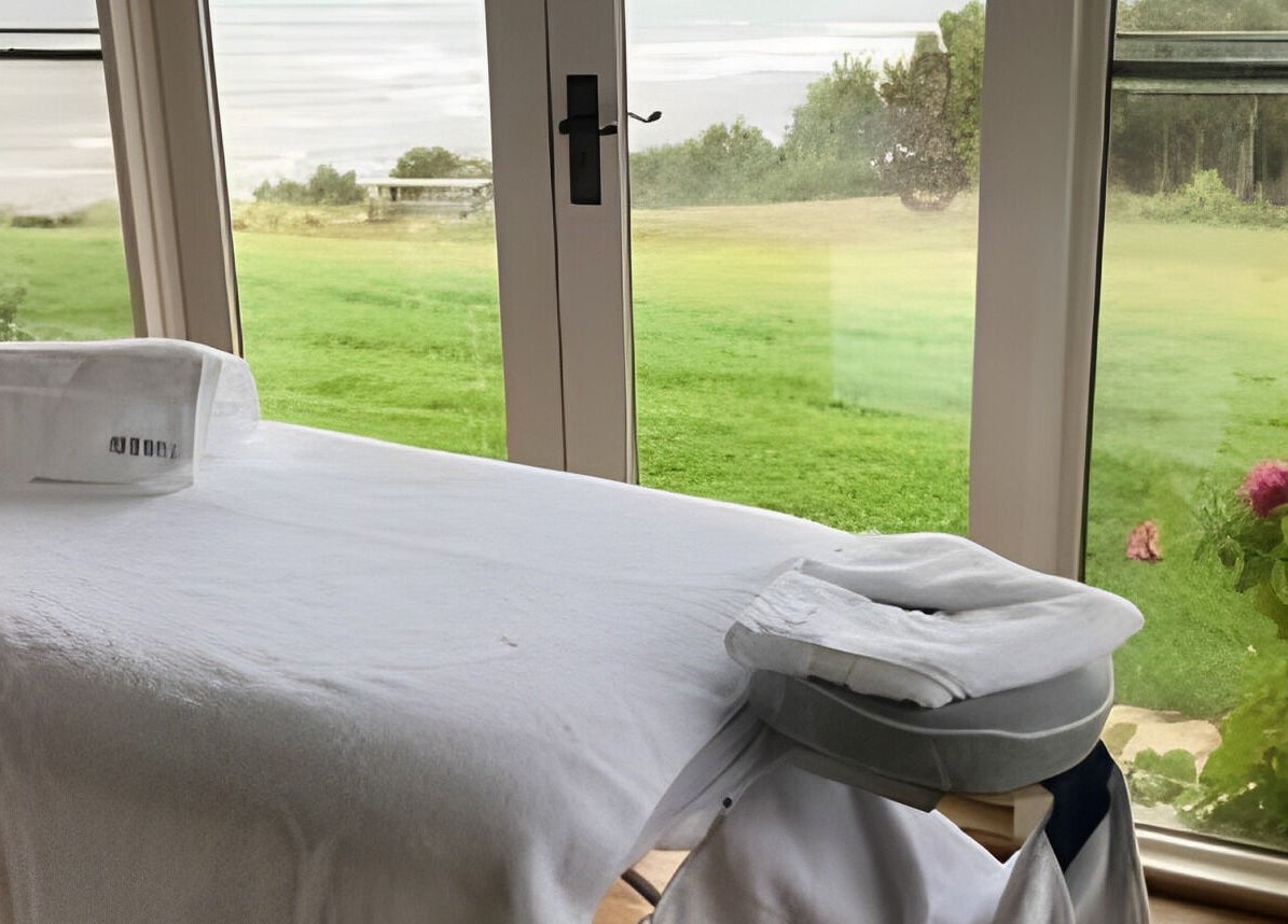 Massage table overlooking lush greenery at The Palms Studio, Waihi, Waikato, NZ.