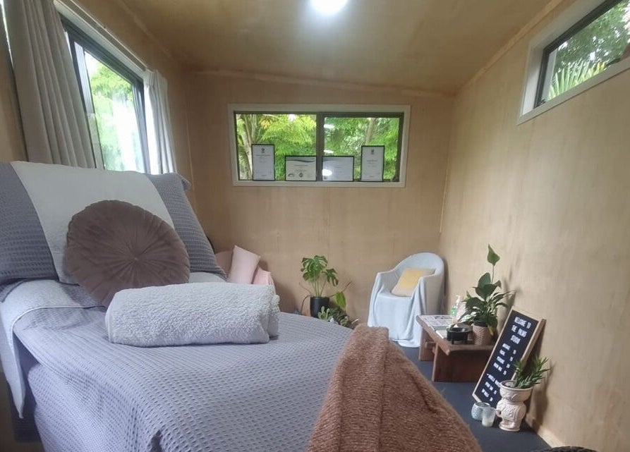 Relaxing treatment room at The Palms Studio in Waihi, Waikato, NZ with cozy decor and natural light.