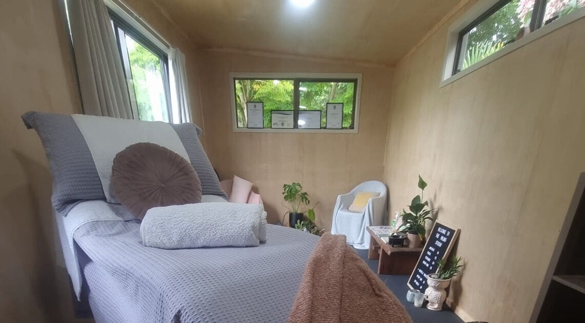 Relaxing treatment room at The Palms Studio in Waihi, Waikato, NZ with cozy decor and natural light.