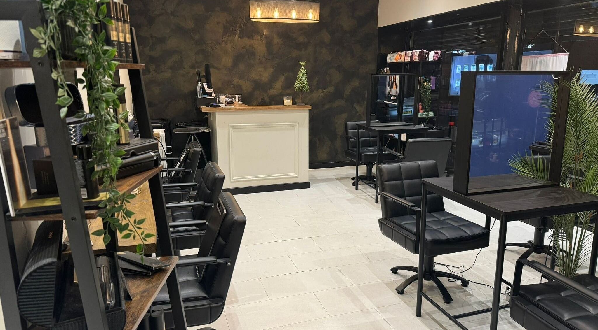 Stylish interior of OAK Salon Hair and Beauty, Hamilton, Scotland, GB, featuring modern chairs and decor.