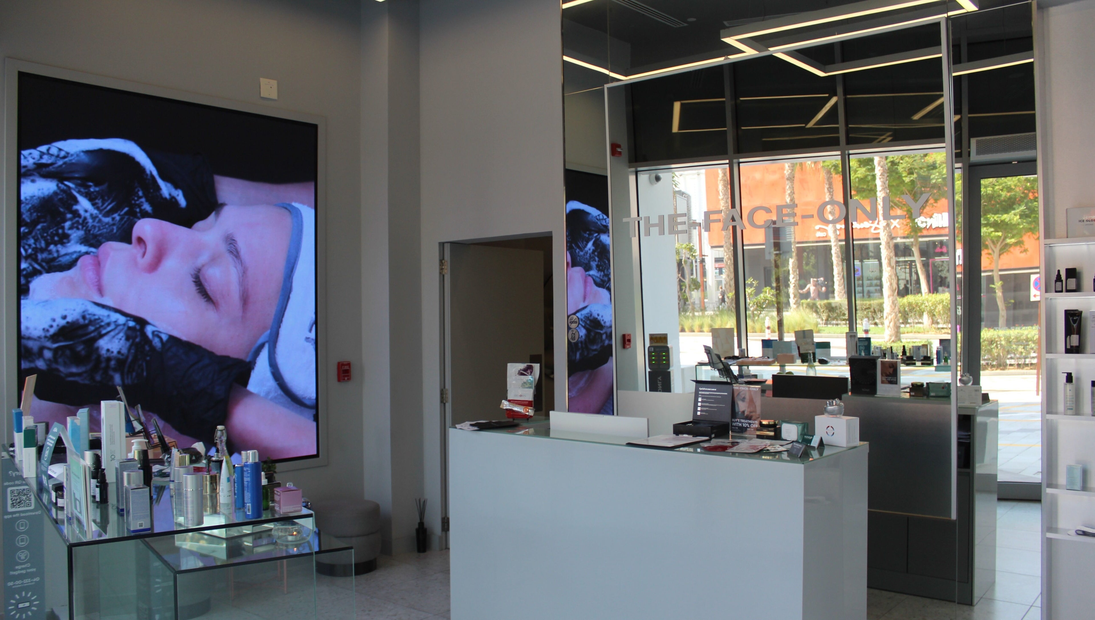 Interior view of The Face Only, Dubai, Dubai, AE showing a modern spa reception with skincare products.