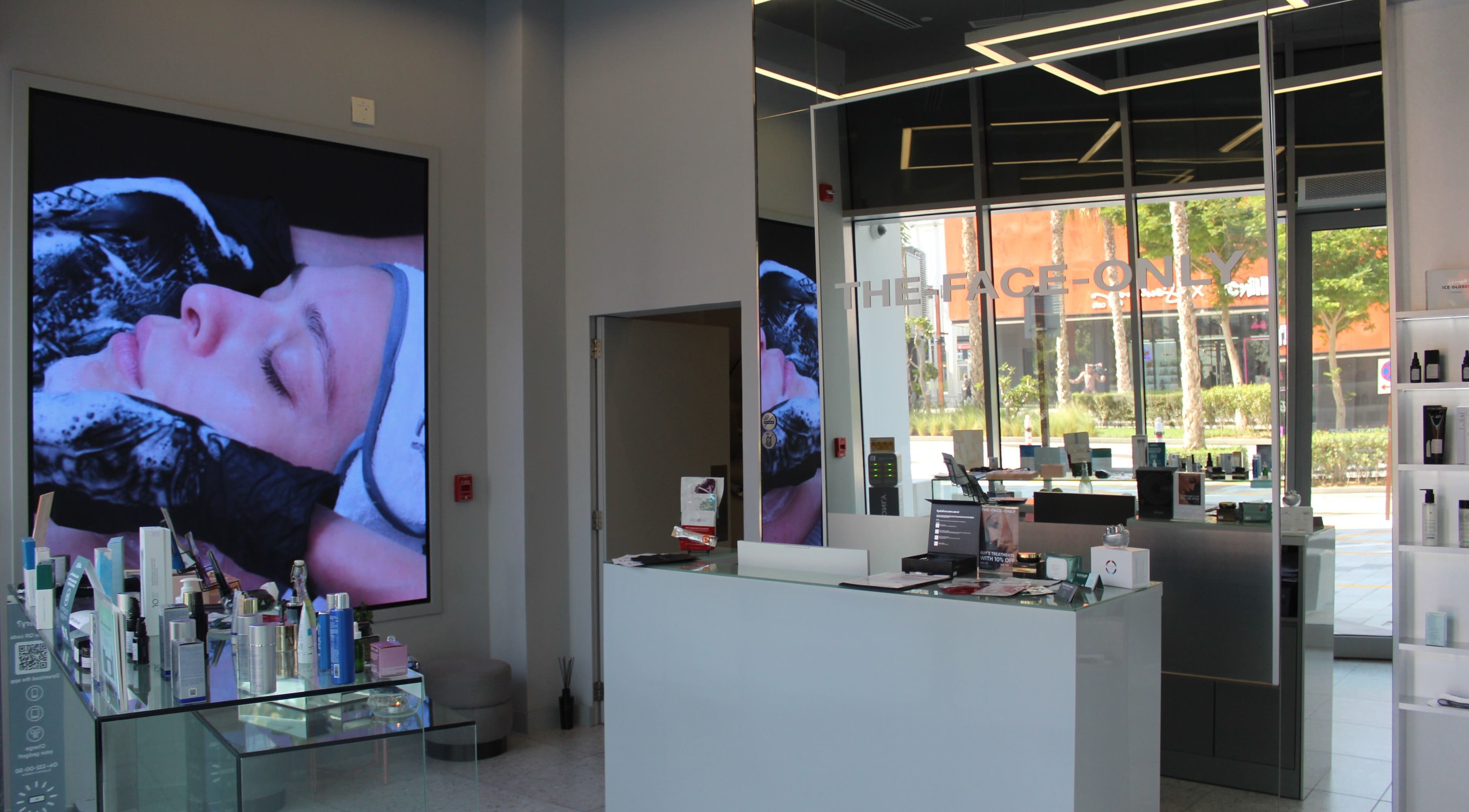 Interior view of The Face Only, Dubai, Dubai, AE showing a modern spa reception with skincare products.